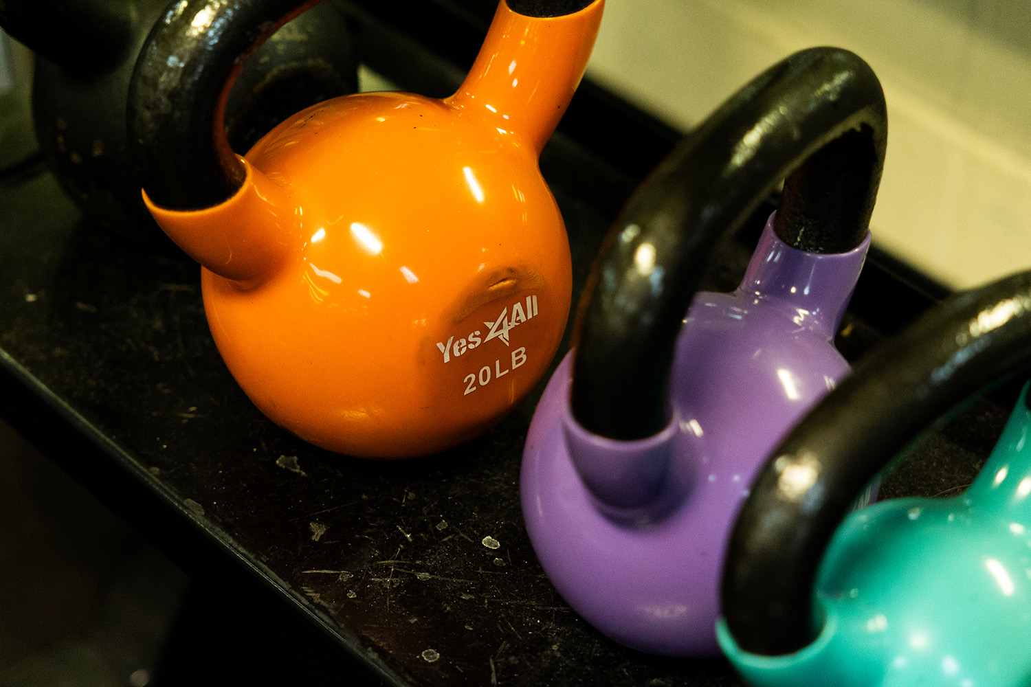 decfdb1f76a83e7c3bba7d6040e5b2dd Children playing basketball in a gym, with two players in red jerseys jumping to reach the ball and two others in purple jerseys actively participating. The YMCA logo is visible in the background, highlighting the community sports environment.